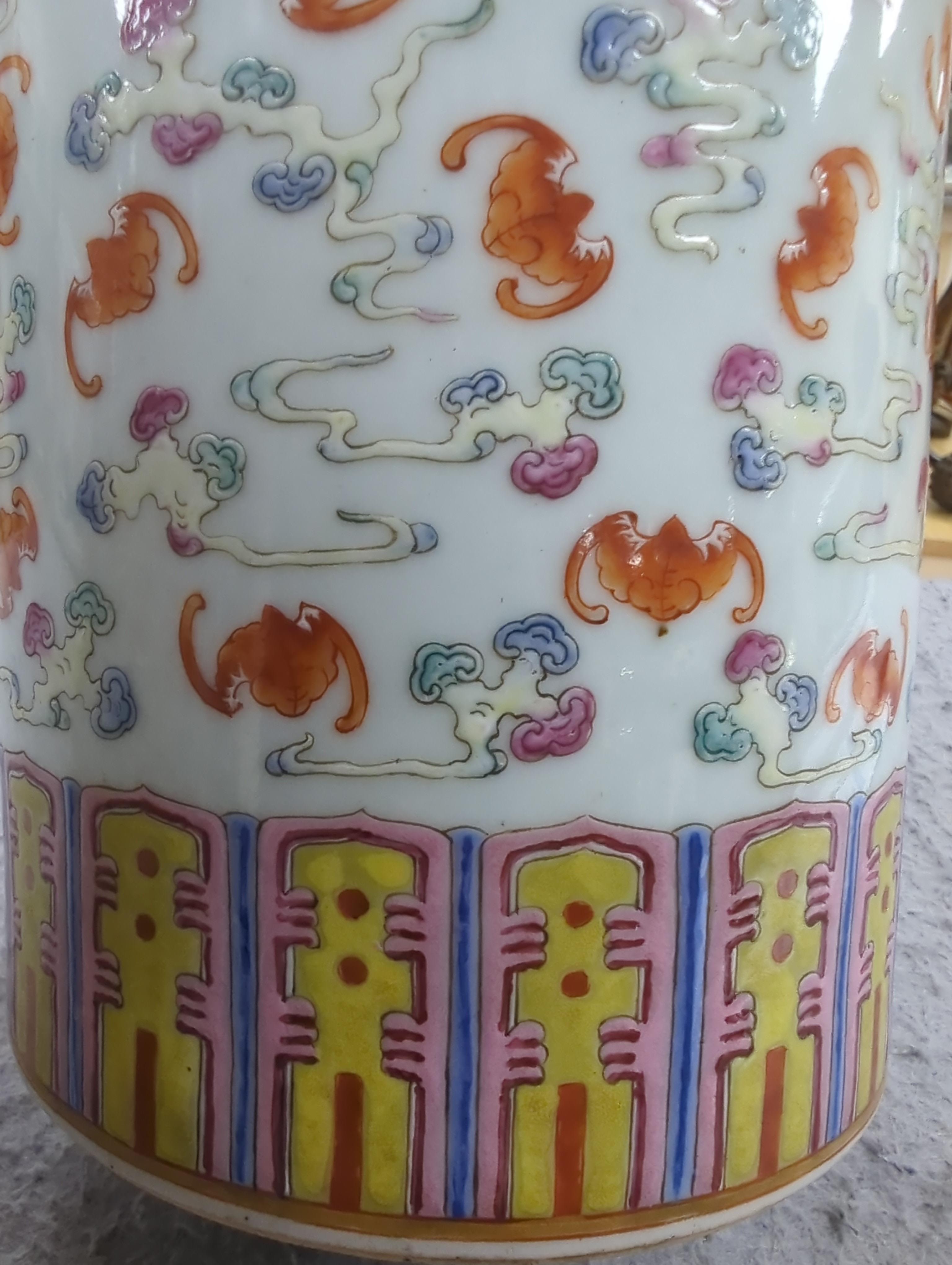 A pair of Chinese famille rose cylindrical vases, decorated with bats, each 29cm high